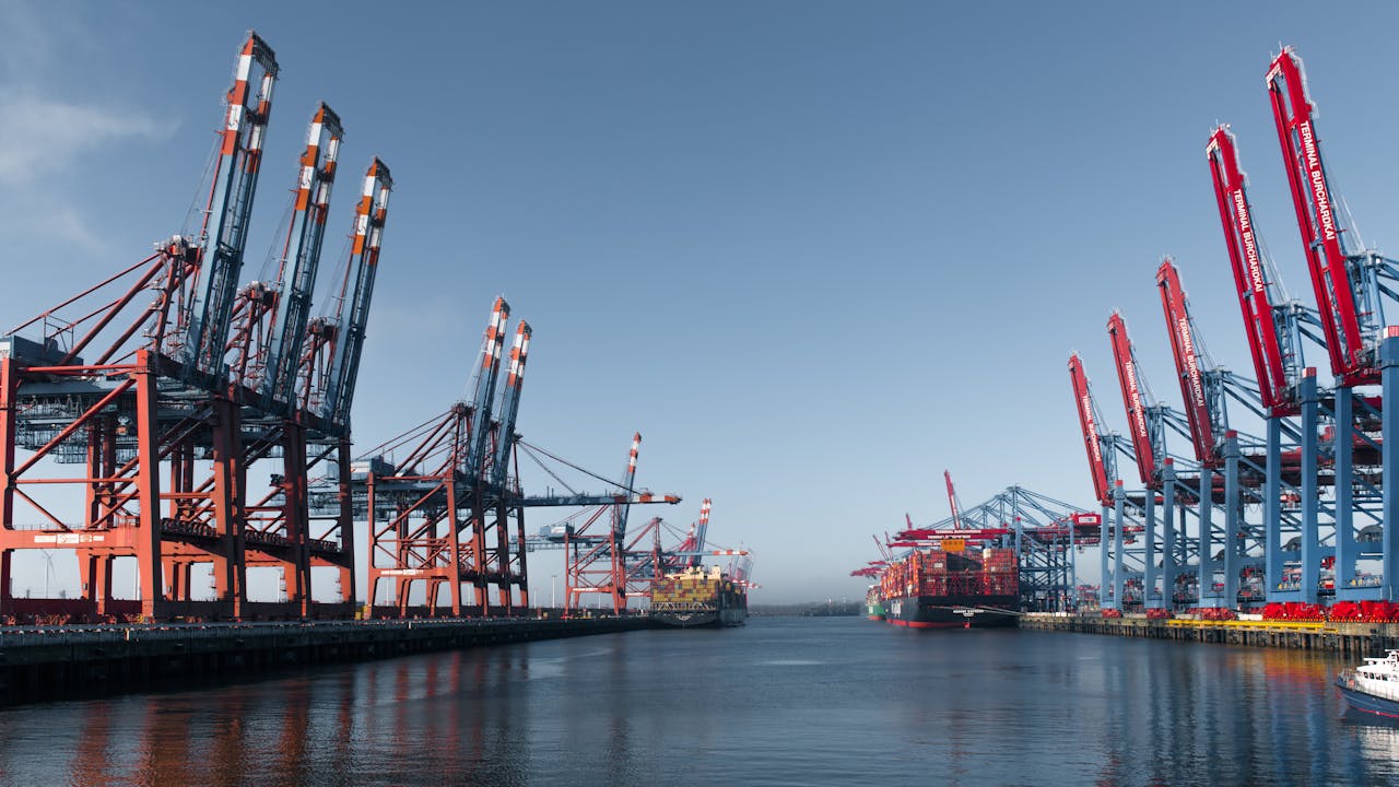 Panoramic view of Hamburgs bustling container terminal highlighting cranes and cargo ships.